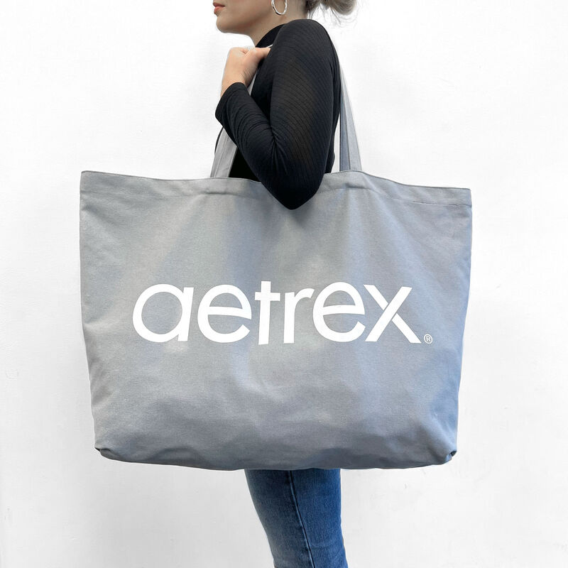 grey aetrex tote bag on shoulder